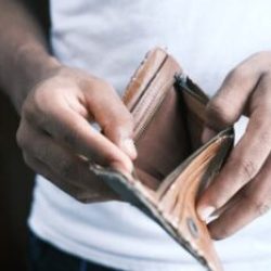 Close-up of hands holding an empty wallet, highlighting financial struggles and economic crisis.